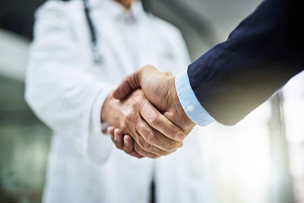 Doctor and partner shaking hands