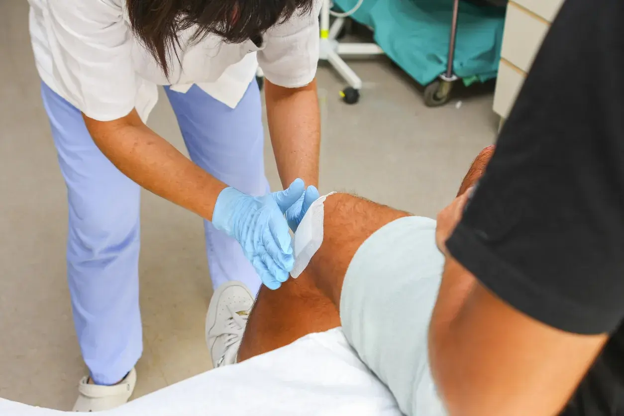 A clinician attending to a patient's knee