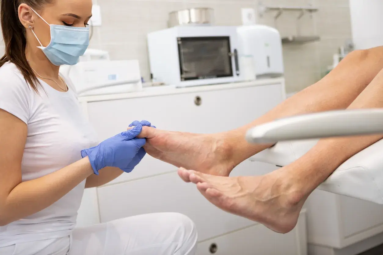 A clinician closely examining a patient's skin