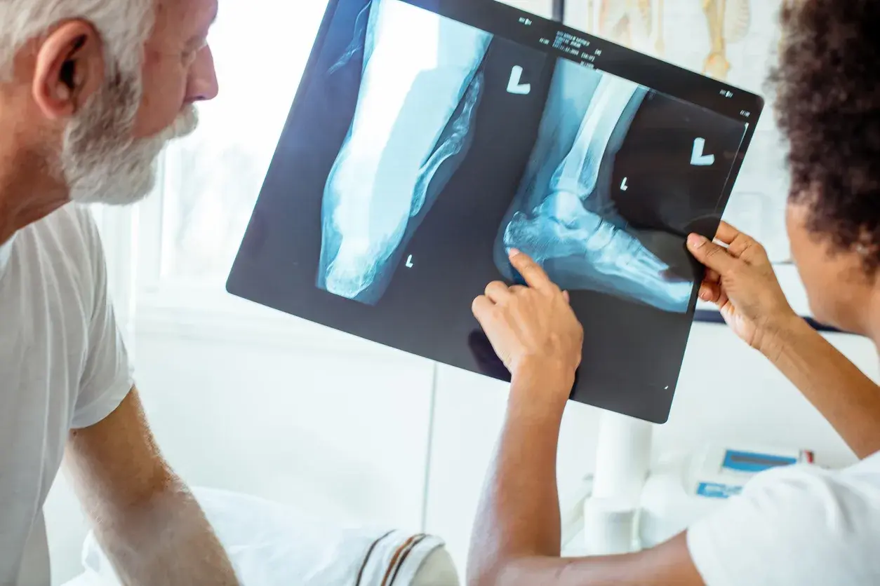 A doctor and patient reviewing an X-ray together