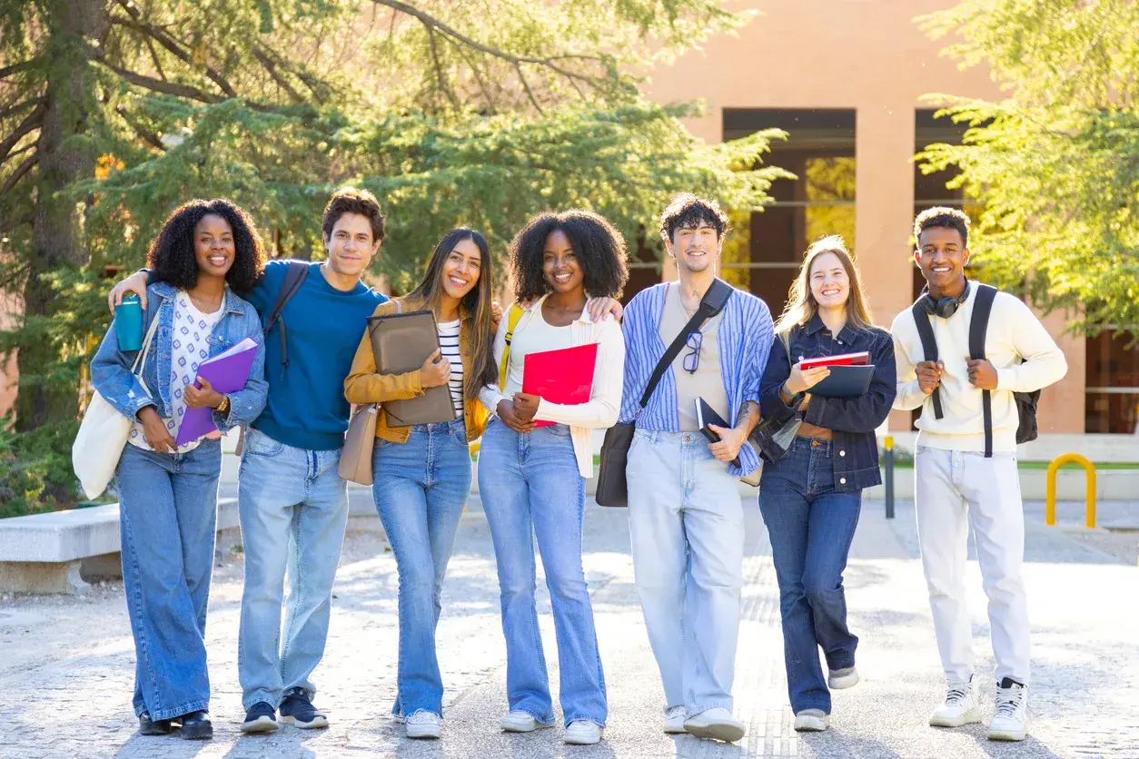 A group of university students standing together on campus